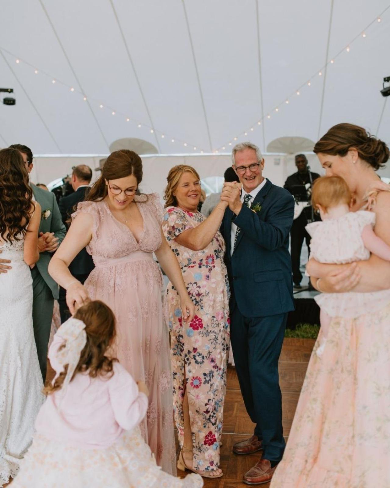 Jeffrey dancing with his wife, surrounded by his three daughters.