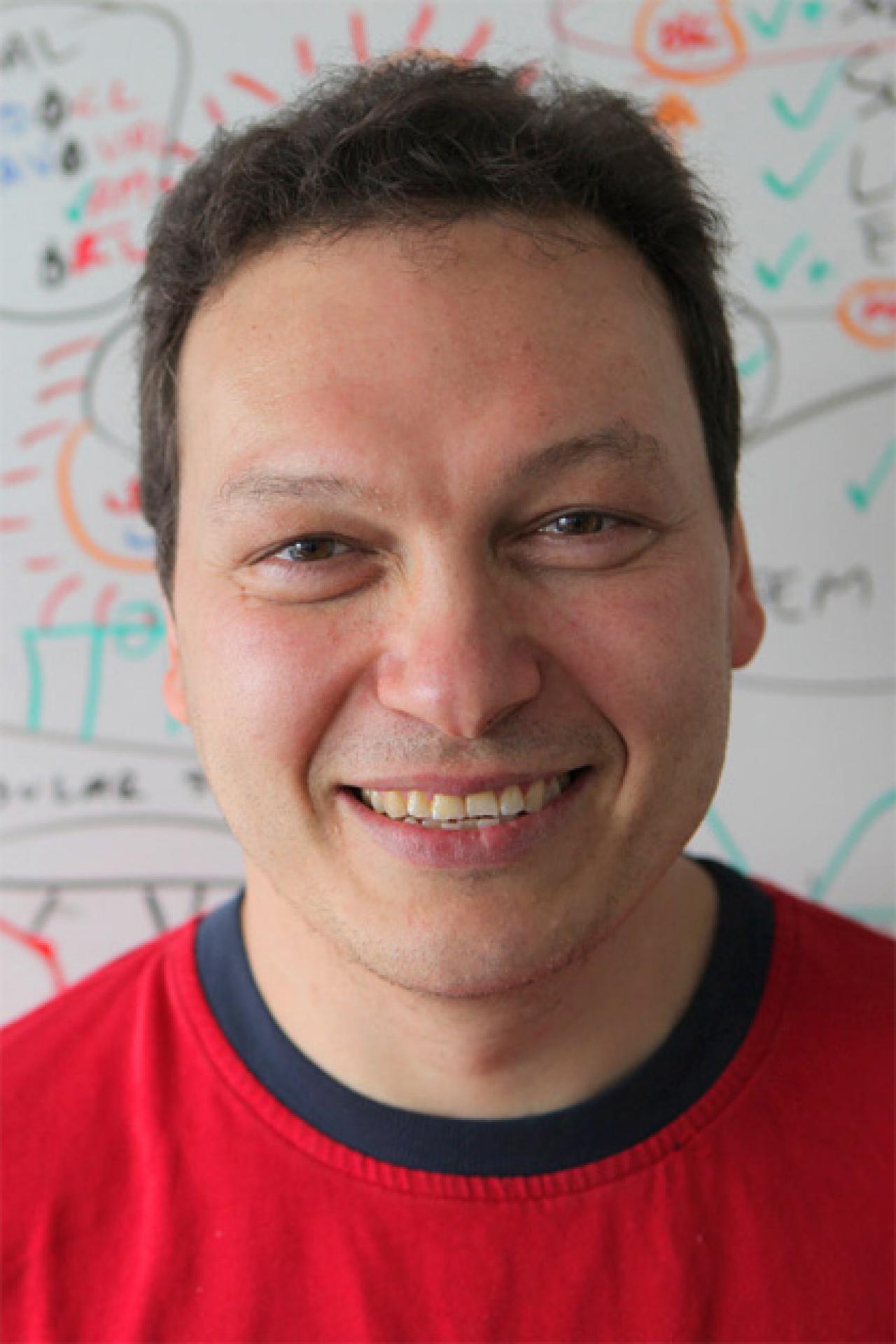 Headshot of Dr. Dranovsky in front of a white board