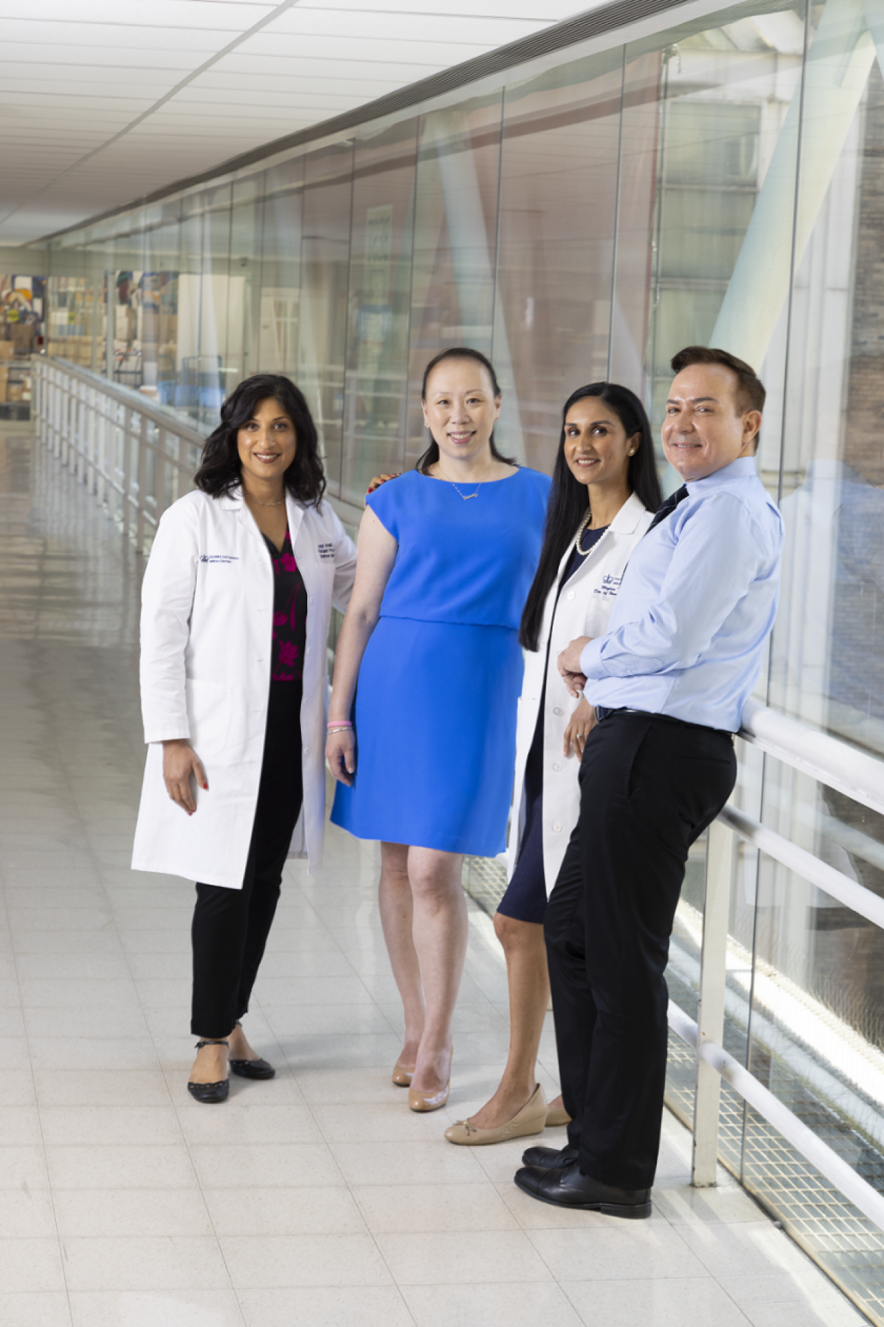 Elaine Alden pictured with her Columbia Cancer care team Group of physicians with patients at hospital walkway