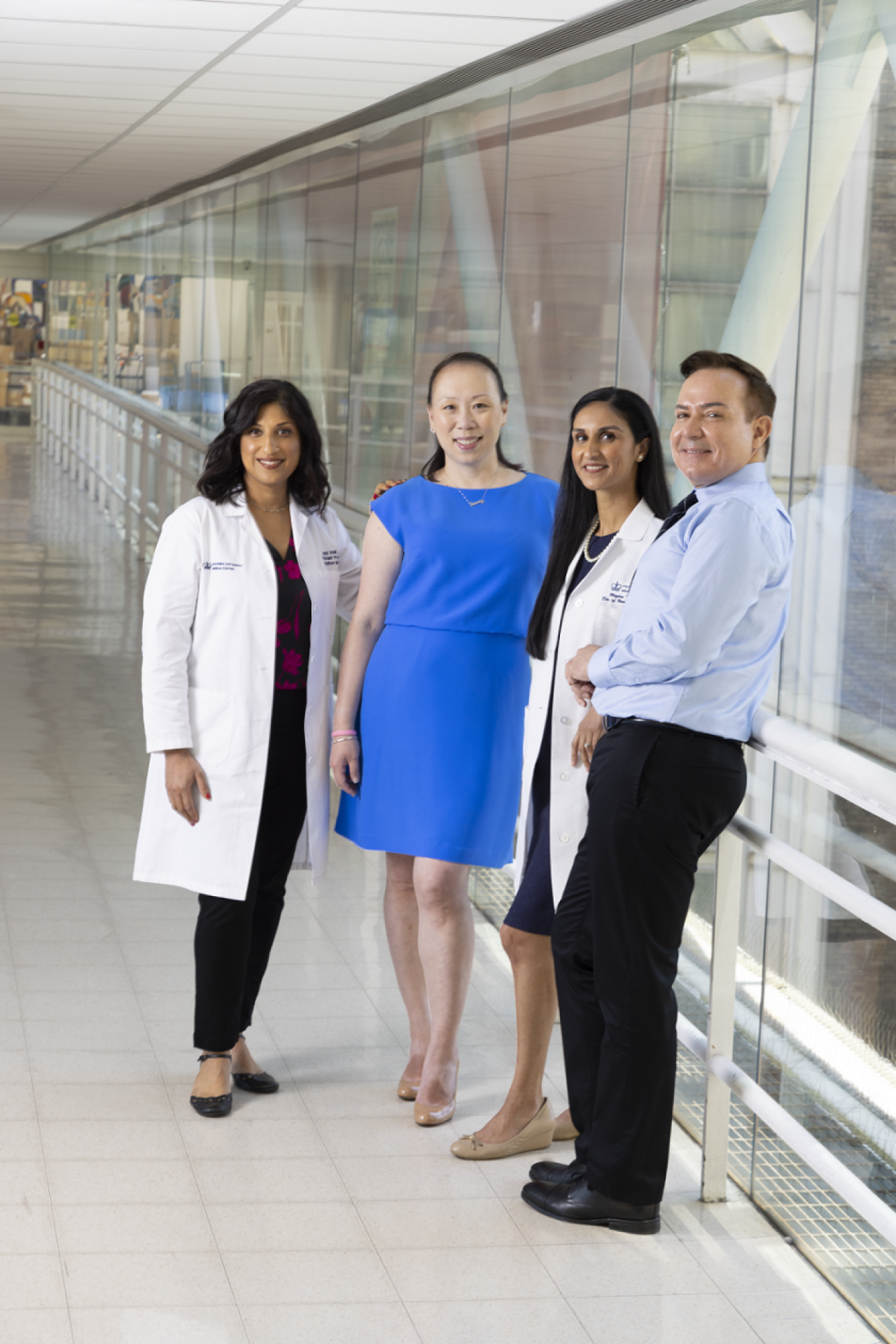 Group of physicians with patients at hospital walkway