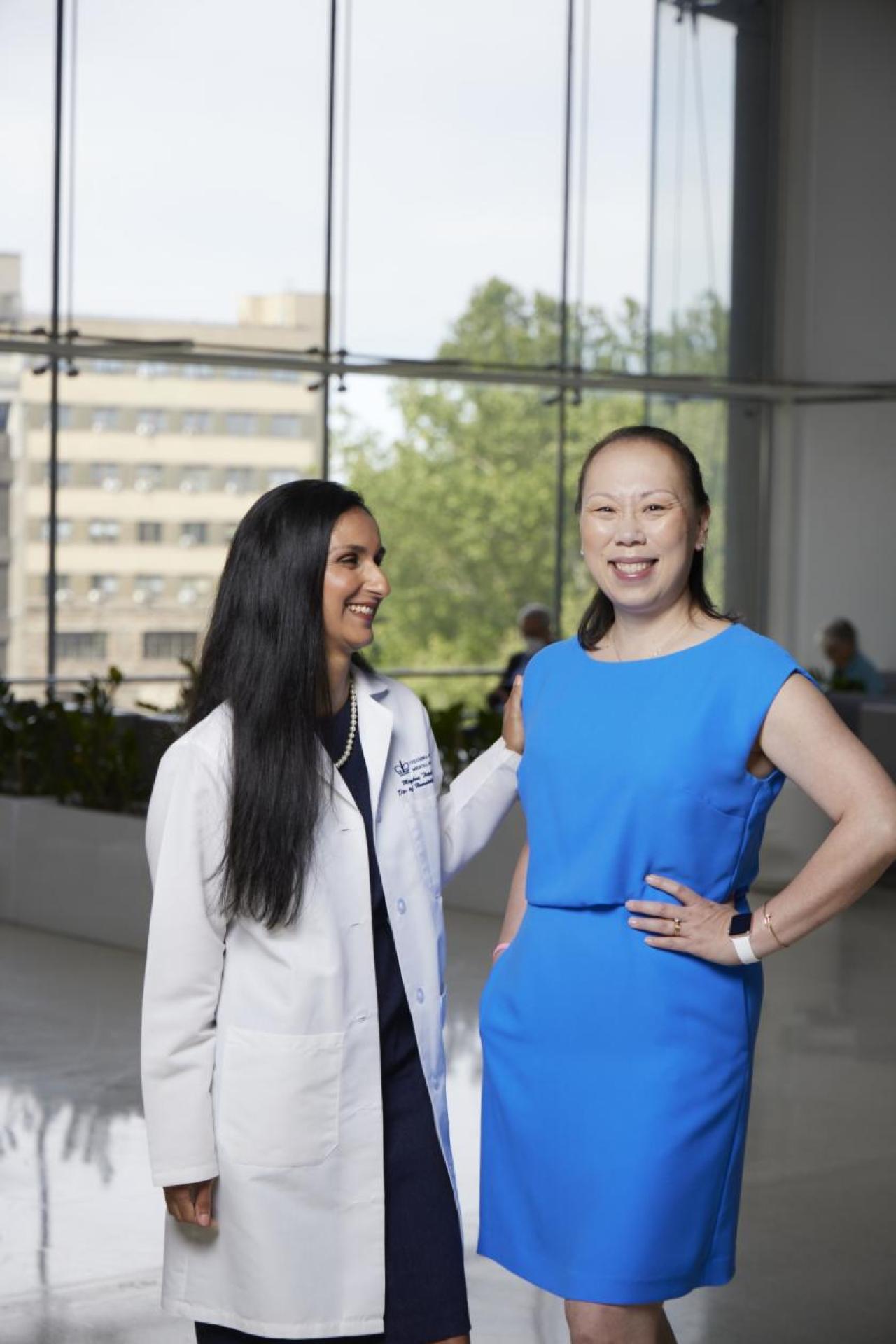 Elaine Alden with her oncologist, Dr. Meghna S. Trivedi Portrait of physician and patient smiling at the hospital