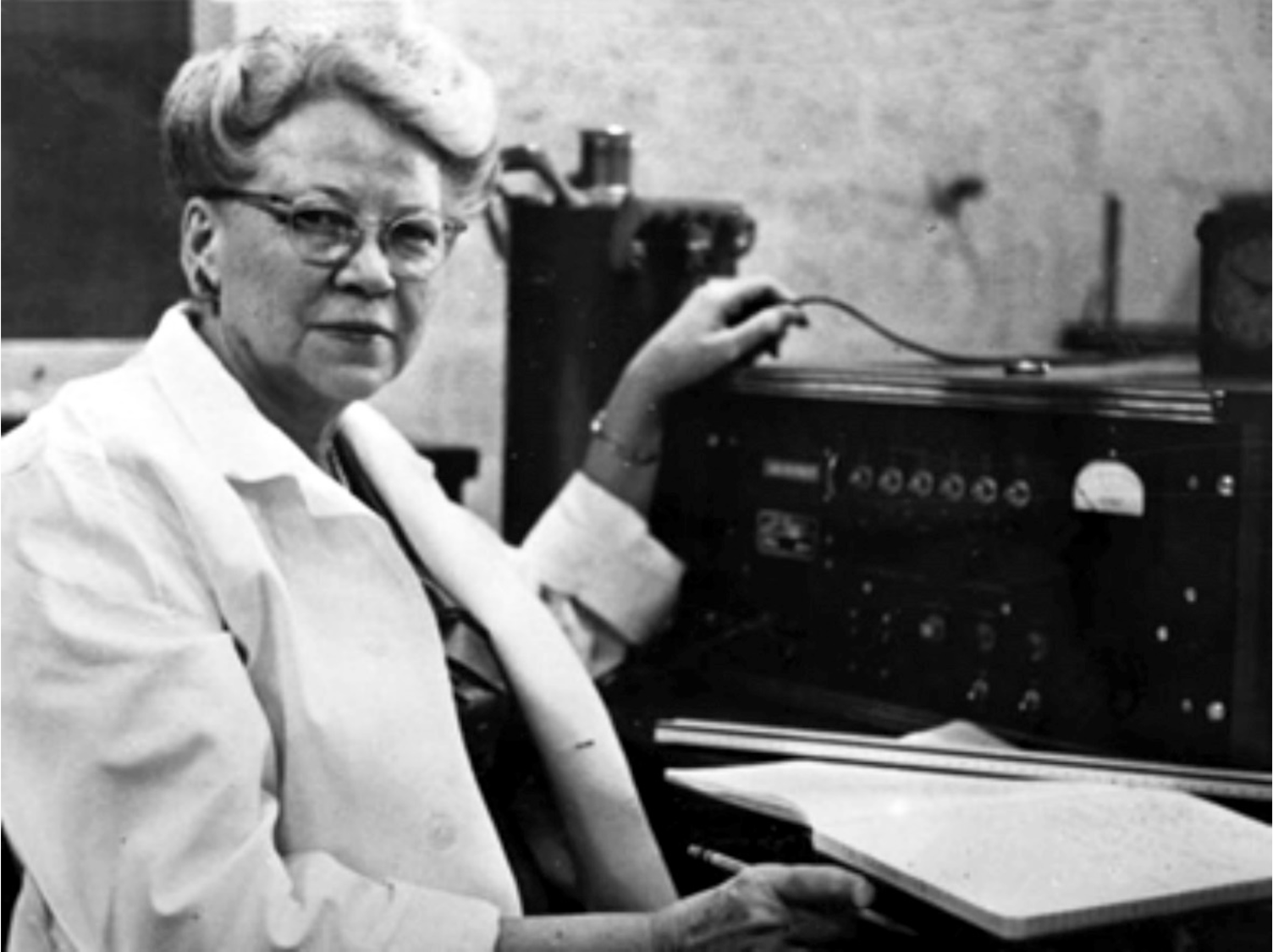 Black and white photo of Dr. Edith Quimby with equipment in lab