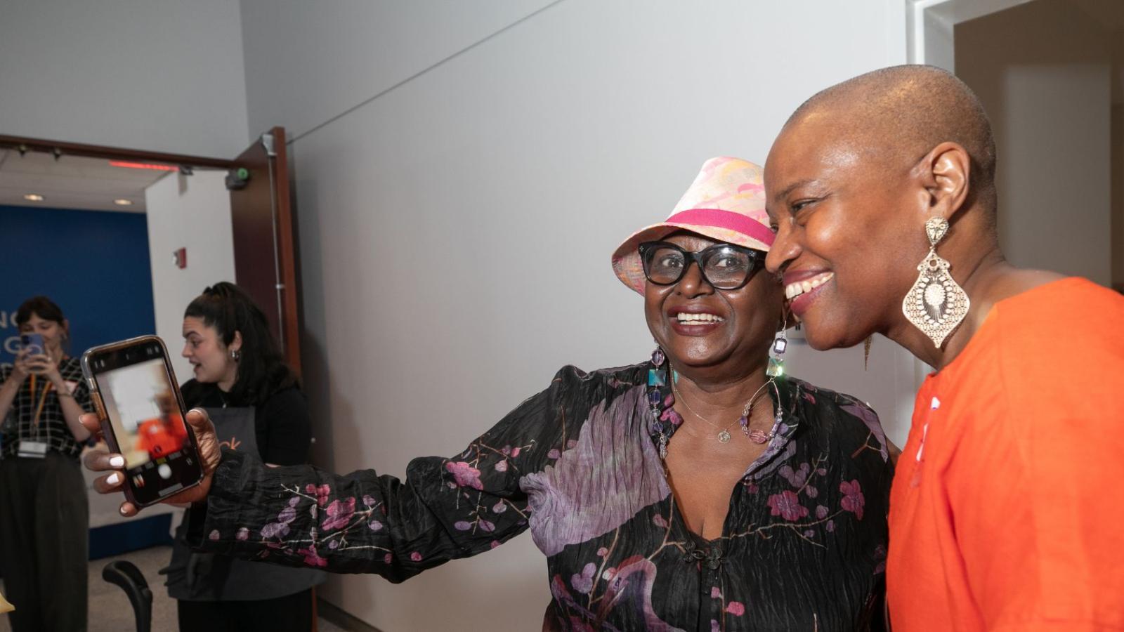 Two women taking a selfie together at the survivors' day event
