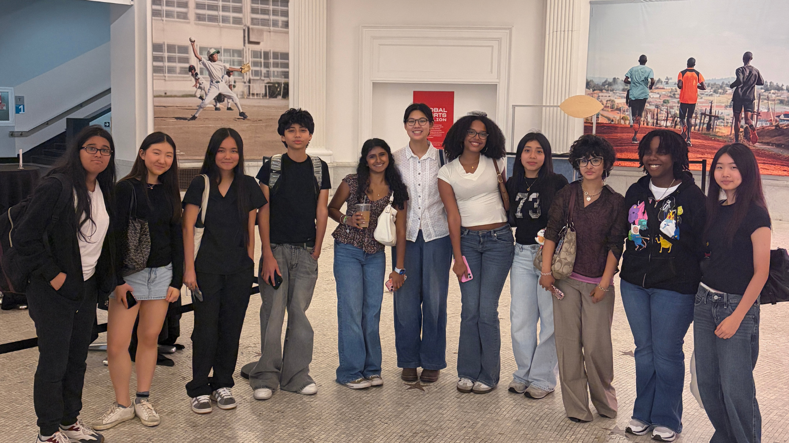 11 students of HICCC's YES in THE HEIGHTS internship program standing next to each other