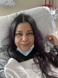 Alondra smiling on the hospital bed