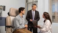 Male patient speaks with female and male doctors