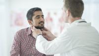 Male patient receives thyroid exam