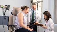 Two doctors consult with a female patient
