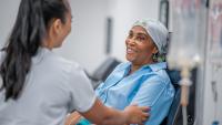 Patient speaking with doctor while receiving chemotherapy