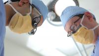 Two urology surgeons working side by side in the operating room