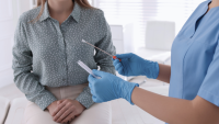 Doctor opening test swab in front of patient