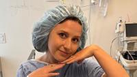 Katie Thurston in the hospital wearing a hospital cap and gown