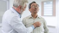 A doctor checking an older adult with a stethoscope.