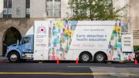 The lung cancer screening van parked on a new york city street.