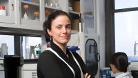 Elisa Konofagou looking at the camera with a lab in her background.
