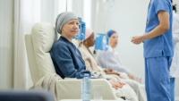 A patient sitting and speaking with a healthcare provider.