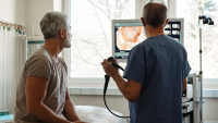 A healthcare provider showing a patient colonoscopy results