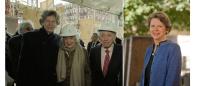 Photo of Karen Antman at the site of the future Irving Cancer Research Center with with Herbert and Florence Irving, wearing hardhats; and a headshot of Karen Antman