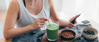 person preparing health food, looking at phone